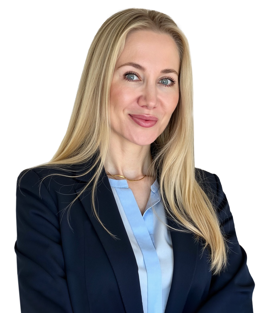 Professional portrait of a smiling blonde woman in a navy blazer in a bright office setting in the background
